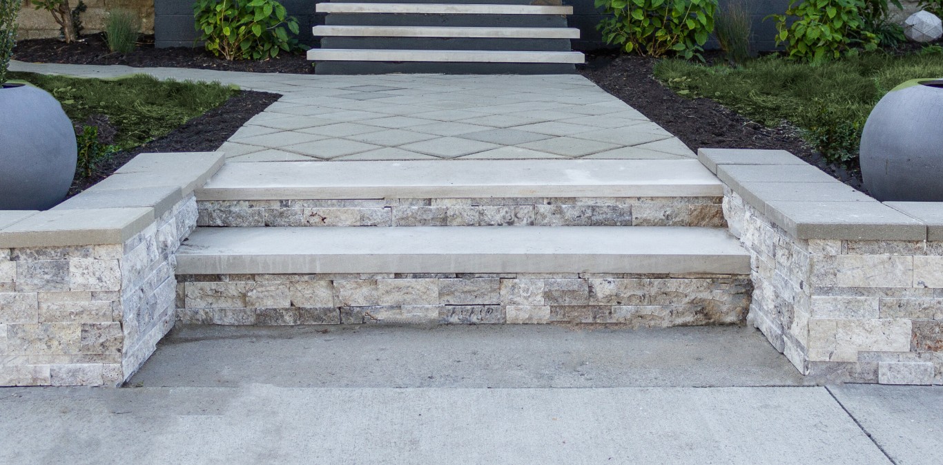 Stone-faced concrete steps and paver walkway installed at a residential entryway in Little Rock, AR